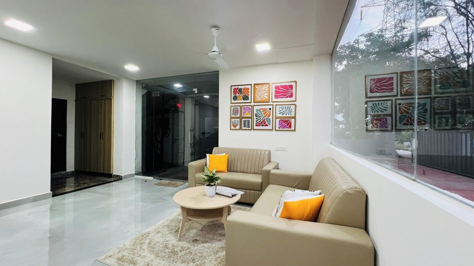 A modern living room with a sofa, coffee table, and artwork on the wall.