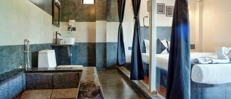 A bathroom with a sink, mirror, and shower curtain.