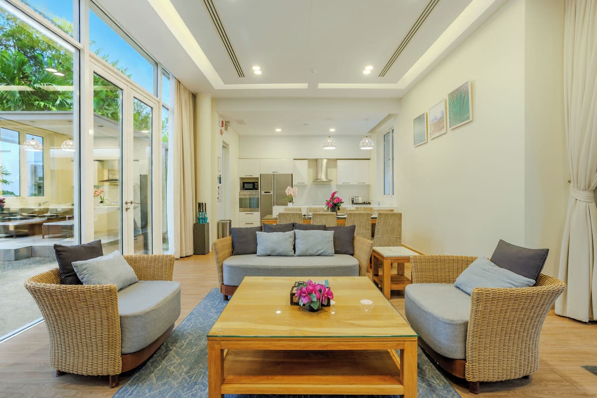 A modern living room with a sofa, chairs, and a coffee table.