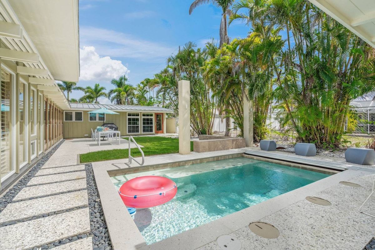 Private splash pool in the backyard, covered with palms and bamboo