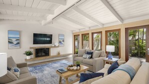 A spacious living room with a fireplace, a television, and comfortable seating.