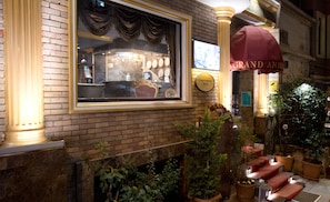 A hotel lobby with a large window, a clock, and a sign for Grand Ambiance Hotels. - Grand Ambiance Hotel (Istanbul)