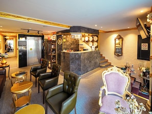 A hotel lobby with leather seating, a reception desk, a clock, and a staircase. - Grand Ambiance Hotel (Istanbul)