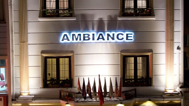 A hotel named "Ambiance" with a classic facade, multiple windows, and a prominent entrance with a red carpet leading to the doors. - Grand Ambiance Hotel (Istanbul)