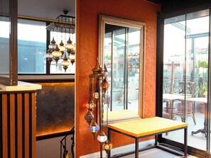 A room with a large window, a table, and hanging decorative lanterns. - Grand Ambiance Hotel (Istanbul)