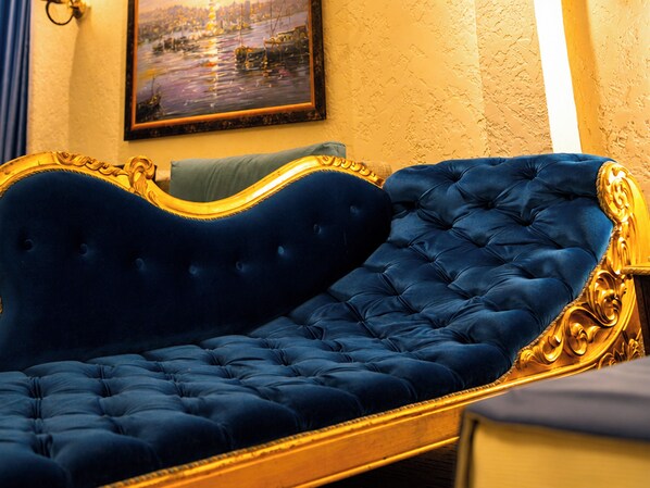 A room with a large, ornate bed with a tufted headboard.
