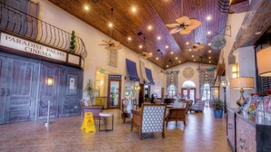 A spacious lobby with a cinema sign, wooden ceiling, and seating area. - 8893 Candy Palm Road (Kissimmee)