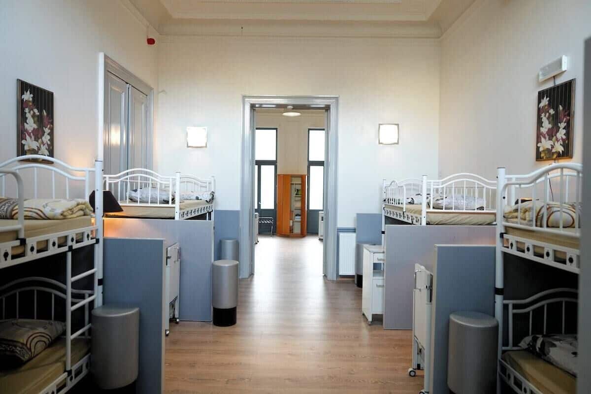 Un dormitorio con literas, un pasillo y una puerta que da a otra habitación.