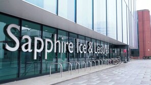 A modern building with the sign "Sapphire Ice & Leisure" indicating a leisure and ice-related facility.