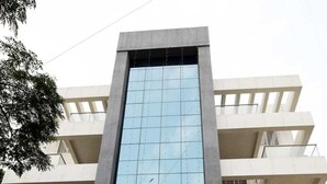 A modern building with a reflective glass facade, multiple balconies, and a sign indicating it is a hotel. - Saara Residency (Pune)
