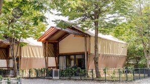 A bungalow-style accommodation with a pitched roof, large windows, and a covered outdoor area. - Gapyeong High Mong Glamping & Camping (Gapyeong)