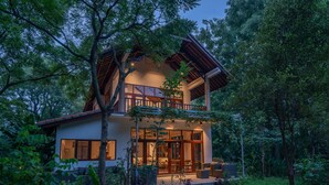A two-story house with a balcony, surrounded by dense forest. - Luxury Living in Harmony with Nature! (bali)