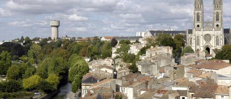 A historic town with a prominent church, a water tower, and a bridge.