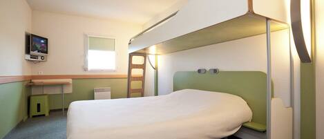 A bunk bed room with a desk and a television.
