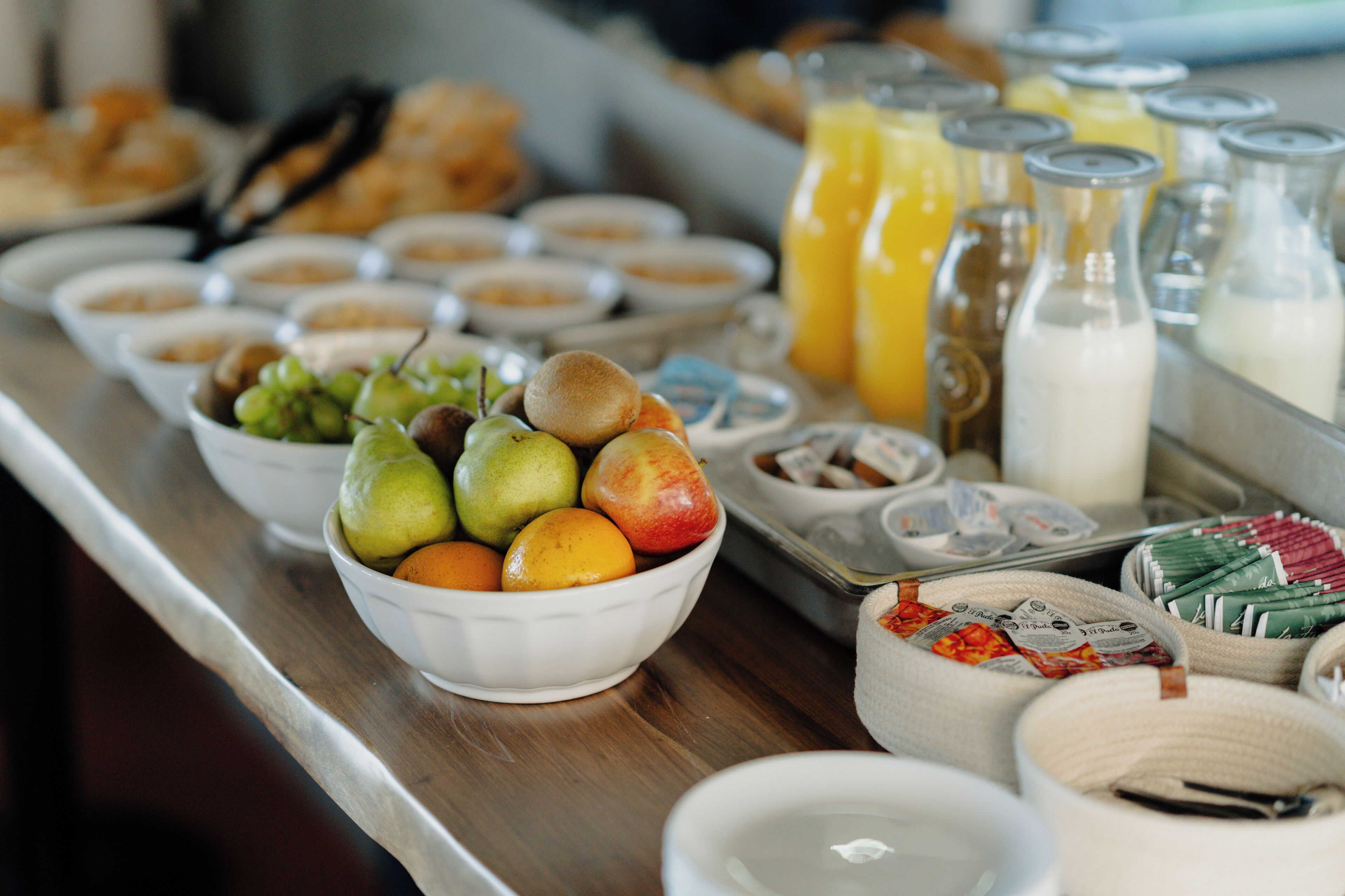 A buffet table with various food items and beverages.