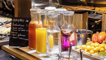 A beverage station with various drinks and a sign listing available options.