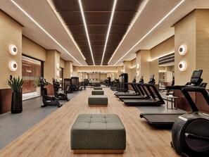 A modern gym with treadmills, elliptical machines, and free weights. - Swissôtel Tashkent (Tashkent)