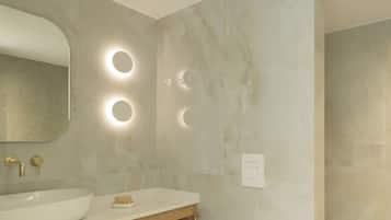 A modern bathroom with a large oval sink, a wooden vanity, a mirror, and three wall-mounted lights.