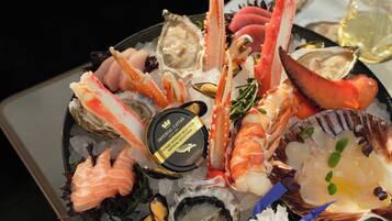 A seafood platter with various types of shellfish and a selection of oysters on ice.