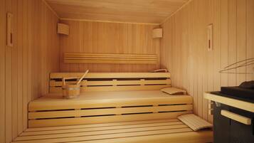 Una sauna de madera con bancos y un cubo de madera.