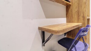 A corner with a wooden shelf and a chair. - WIND FLOWER (Mumbai)