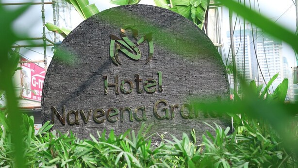 A sign for Hotel Nguyeem Garden with a logo above the text. - Hotel Naveena Grand (Hyderabad)