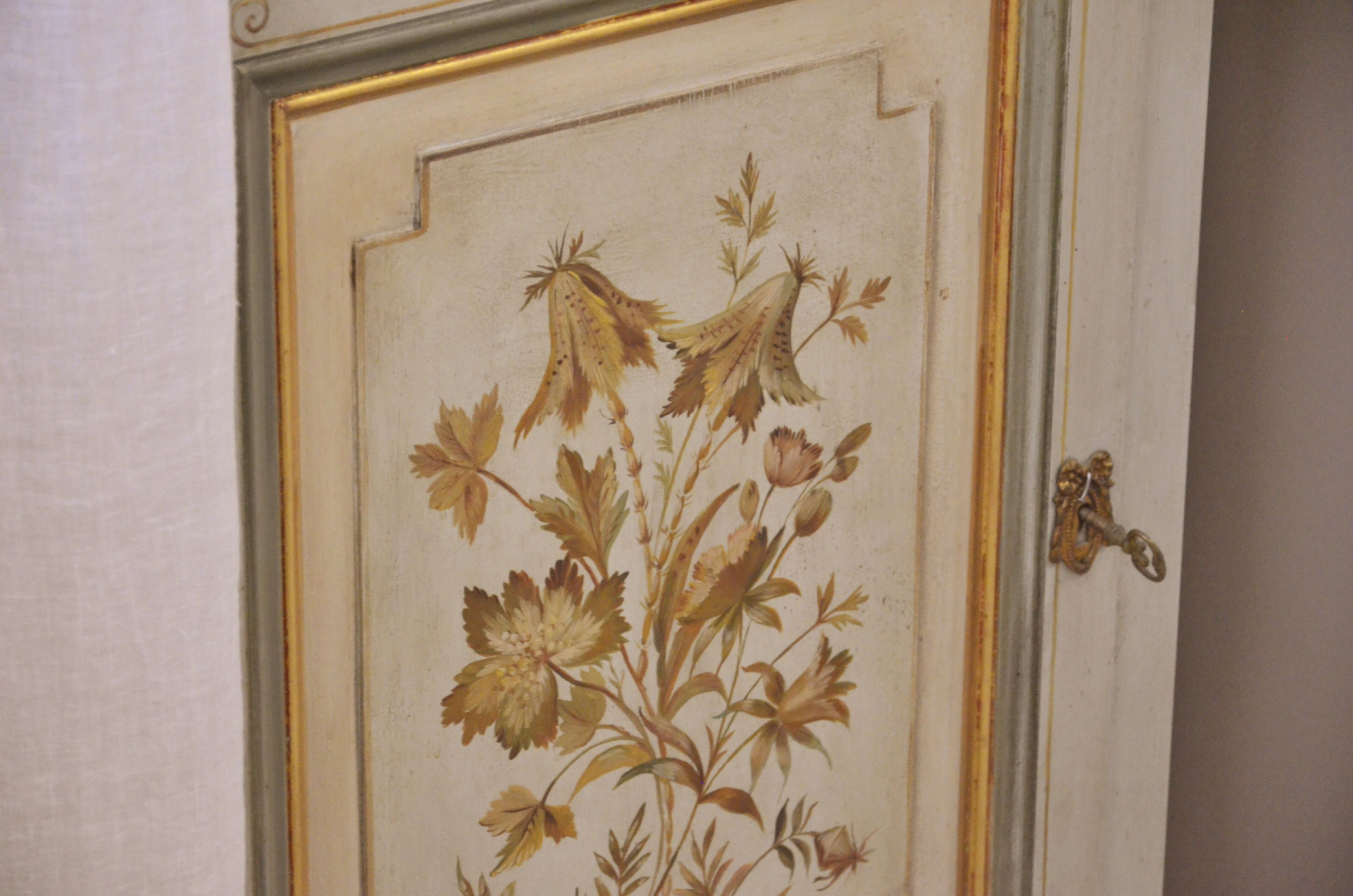 A door with a floral design and a brass handle.