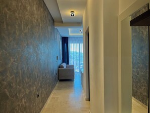 Luxury Suite, Partial Sea View | Living area | 70-inch Smart TV with digital channels