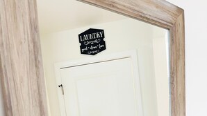A white door with a sign above it that reads "LAUNDRY good clean fun." - The Haven Hideaway in Atlanta (Atlanta)