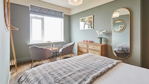 A bedroom with a bed, a dresser, a chair, a desk, and a window. - Host Stay Twelve On The Terrace (Newbiggin-by-the-Sea)