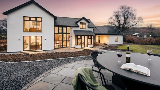 A modern two-story house with large windows and a patio area. - Lily Bank in Staveley (Kendal)