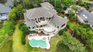 A large, multi-story house with a spacious deck and a swimming pool. - 28 Oyster Landing -  A Magnificent Marsh View in Sea Pines! (Hilton Head Island)