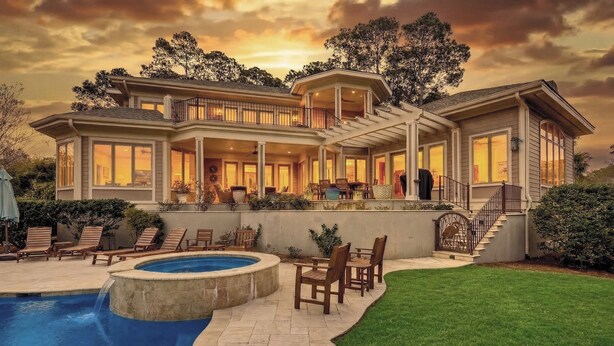 A large house with a pool, outdoor seating, and a staircase leading to the upper level. - 28 Oyster Landing -  A Magnificent Marsh View in Sea Pines! (Hilton Head Island)