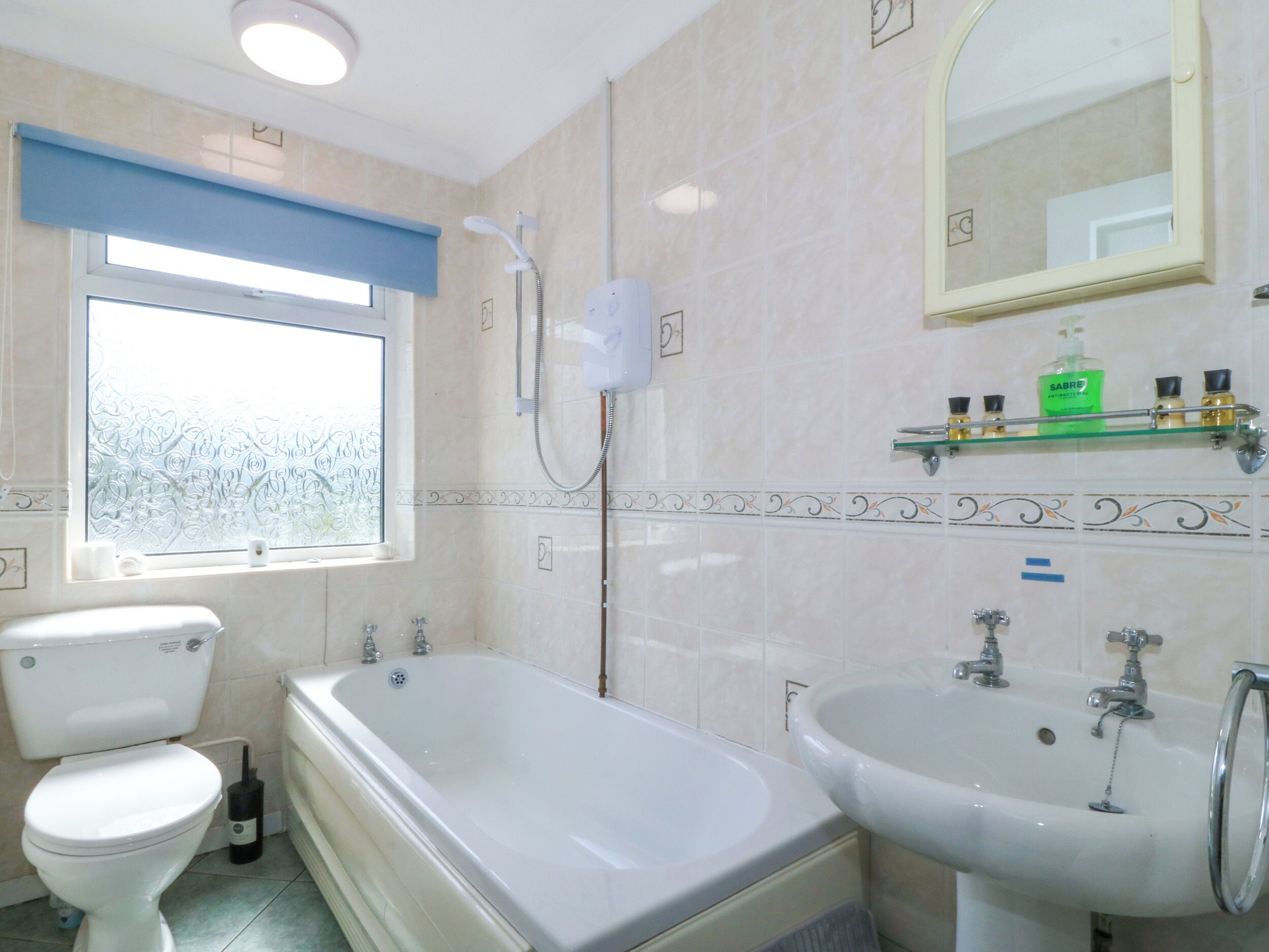 A bathroom with a toilet, a bathtub, and a sink.