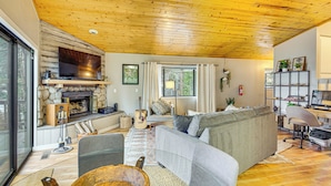 A cozy living room with a fireplace, comfortable seating, and a television. - 2 Mi to Lake Arrowhead: Treetop Retreat w/ Deck (Lake Arrowhead)