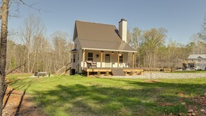 A two-story house with a front porch, a chimney, and a small deck. - 4 Mi to Lake Barkley: Pet-friendly Home w/ Hot Tub (Cadiz)
