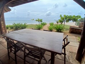 Enjoy a casual dining experience with a view of the ocean from this outdoor seating area.