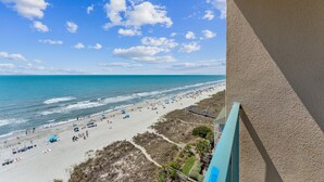 A beach with a clear sky, a sandy shore, and a wooden walkway. - Stunning Ocean Views From The 10th Floor 1 Bedroom Condo (North Myrtle Beach)