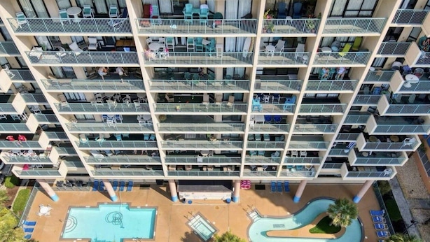 A multi-story hotel with balconies, a swimming pool, and a landscaped area. - Stunning Ocean Views From The 10th Floor 1 Bedroom Condo (North Myrtle Beach)