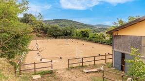 An outdoor equestrian arena with a wooden fence, surrounded by trees and hills in the background. - Gorgeous home in S. Maria in Tiberina (S. Maria in Tiberina)