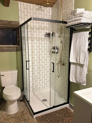 Shower, towels, soap, toilet paper