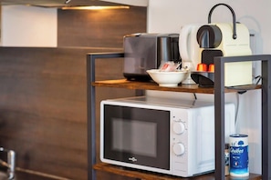 Kitchenette with microwave, toaster, and kettle for convenient meal preparation.