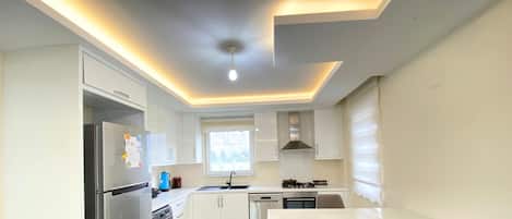 Enjoy cooking in this well-equipped kitchen with a gas stove, stainless steel refrigerator, and sleek cabinetry.