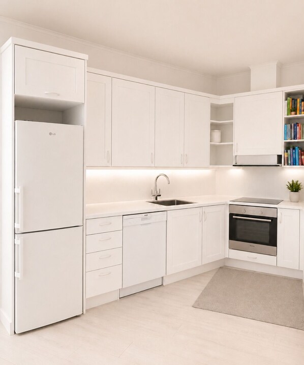 A modern kitchen with white cabinetry, a built-in dishwasher, a stainless steel oven, and a bookshelf with books.