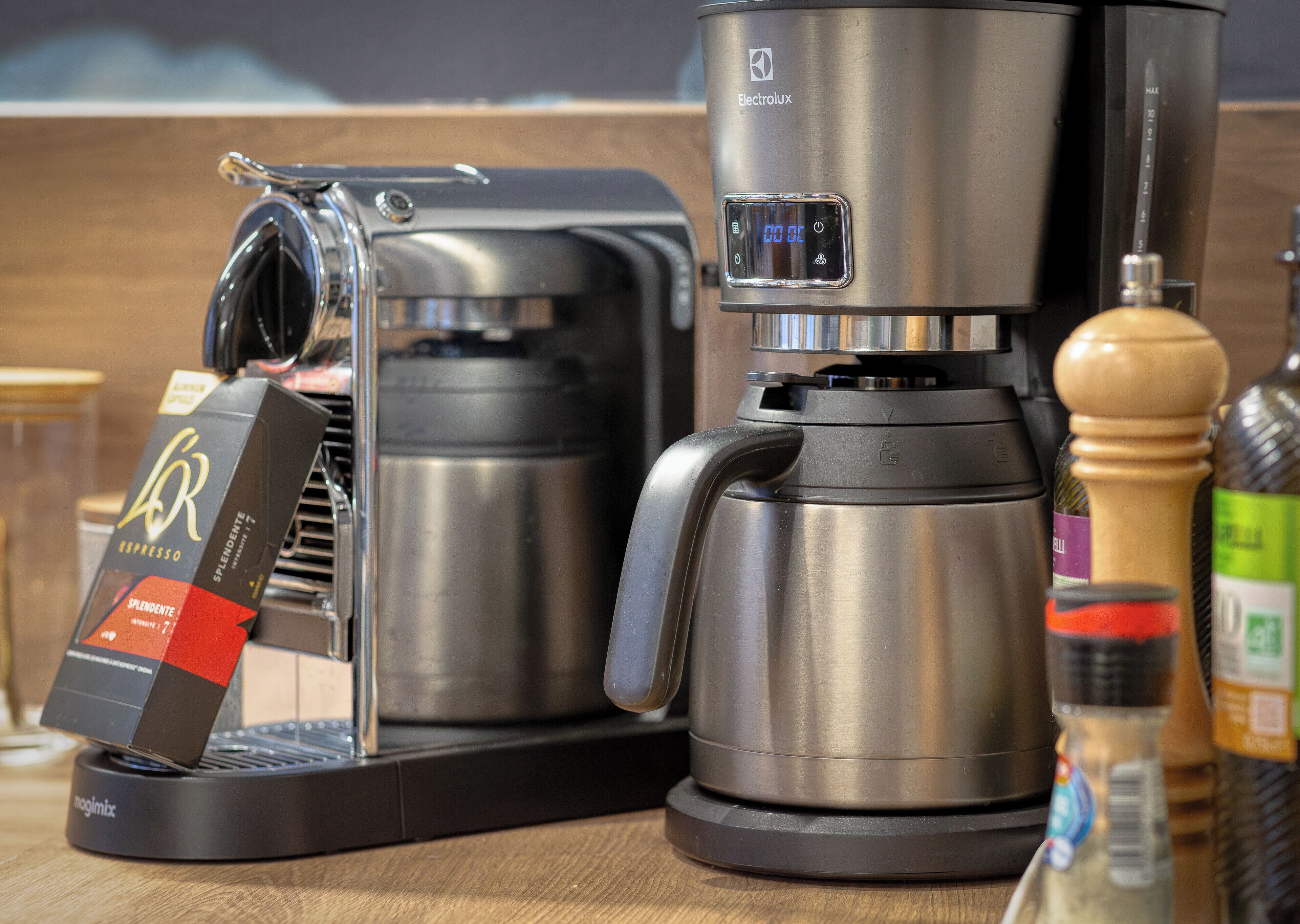 A coffee machine and a box of coffee pods on a kitchen counter.