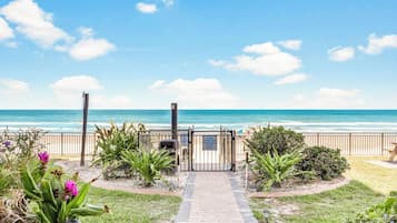 On the beach, white sand, sun-loungers, beach towels
