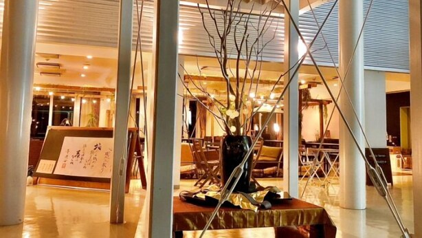 A spacious lobby with high ceilings, a central seating area, and a large vase with branches. - kogikusou (Kikugawa)