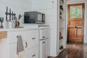 Fridge, microwave, coffee/tea maker, cookware/dishes/utensils