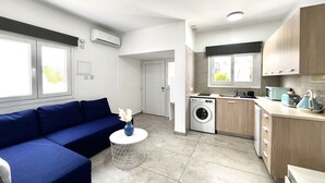 A modern apartment with a living area, kitchen, and laundry room. - 33 AN - Stay Napa Ocean Apartment (Ayia Napa)