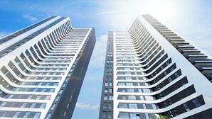 Two high-rise buildings with a modern architectural design, featuring a series of balconies and large windows. - Modern Apartment With Views Urban Sky 26ke (Málaga)